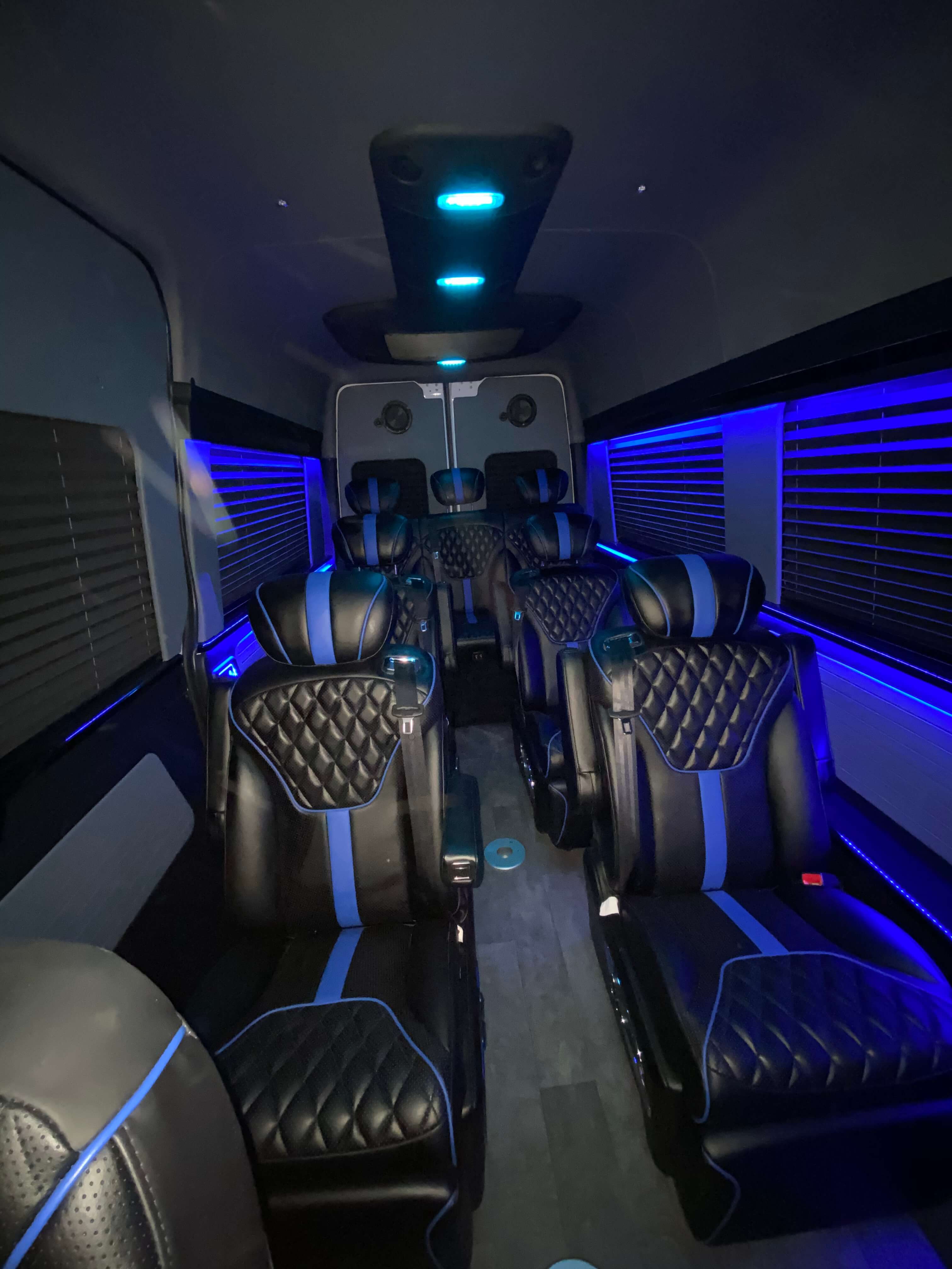 Black and blue leather multi-row van conversion interior with ambient LED lighting