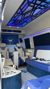 Tablet-based entertainment control mounted in a blue-lit van conversion interior