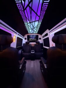 Custom van conversion interior showcasing captain chairs and ambient cabin lighting
