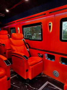 Orange leather captain chair and dashboard detail in a custom Mercedes Sprinter conversion