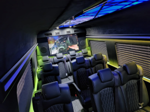 Custom van conversion interior with blue ambient lighting and premium seating
