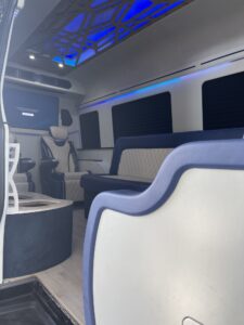 Custom van conversion interior with cream leather captain chairs