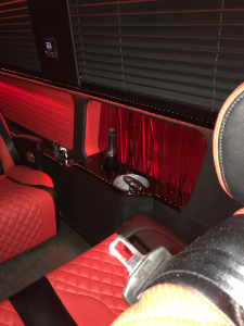 Multi-row cream leather van conversion cabin with monogrammed captain chairs