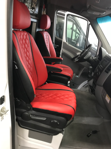 Red leather reupholstered front seats in a Mercedes Sprinter van, custom fabrication in progress