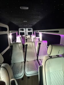 Cream leather multi-row van conversion interior with ambient pink lighting