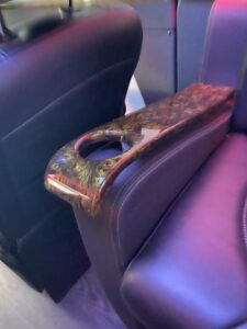 Wood-grain and gold-accent armrest detail, custom fabrication by Luxury Group Mfg