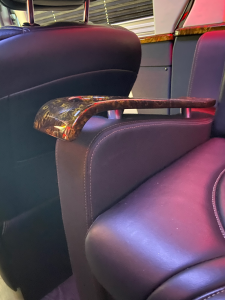 Wood-grain armrest and cupholder detail, custom fabrication by Luxury Group Mfg
