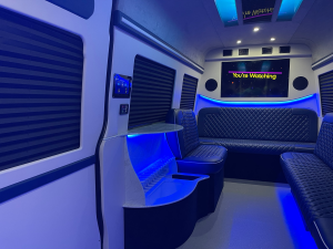 Blue ambient-lit van conversion interior with premium captain seating