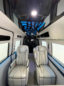 Green-lit van conversion cabin with quilted leather captain seating