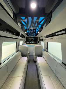Custom van conversion interior with green accent lighting and premium captain chairs